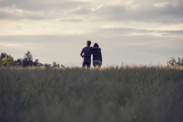 istock Young couple standing in the field 645505668