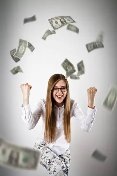 Photo of Rejoicing. Woman in white and Dollars.