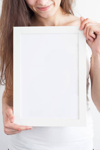 istock Hands of the woman hold a frame with a clean sheet 645530378