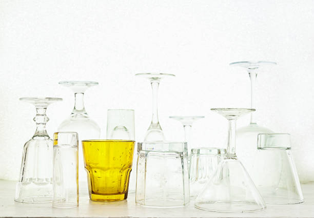 istock Glass goblets of different shapes and a multi-colored on a white 645531552