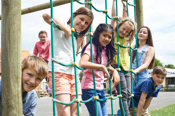 istock Portrait Of School Pupils Playing On Climbing Frame 645534558