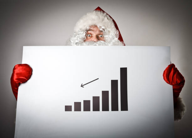 istock Santa Claus is holding a diagram in his hands. 645540124