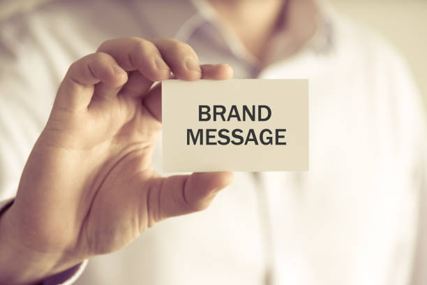istock Businessman holding BRAND MESSAGE card 645543670