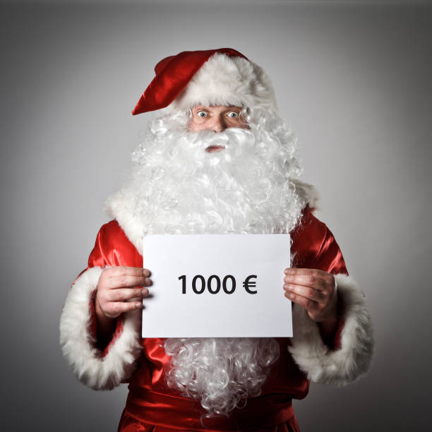 istock Santa Claus is holding a white paper in his hands. 645544446