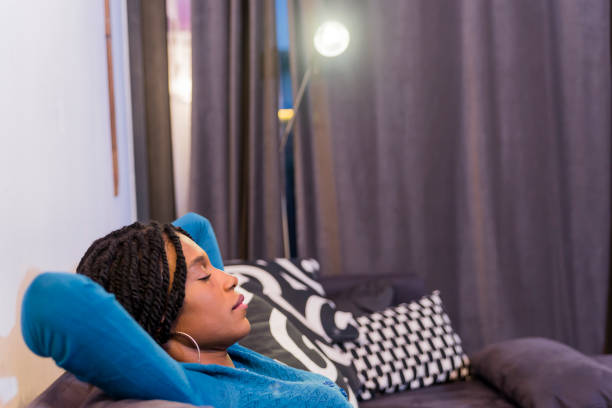 istock Woman relaxing lying on a couch at home 645549394