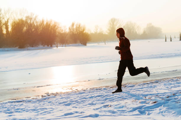 istock Jogging and stretching on cold winter day in snow in nature 645557976