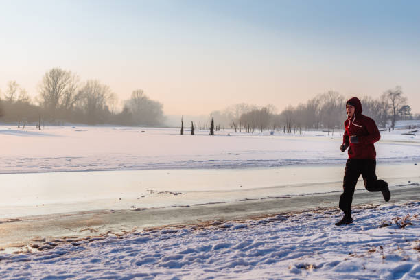 istock Jogging and stretching on cold winter day in snow in nature 645558506