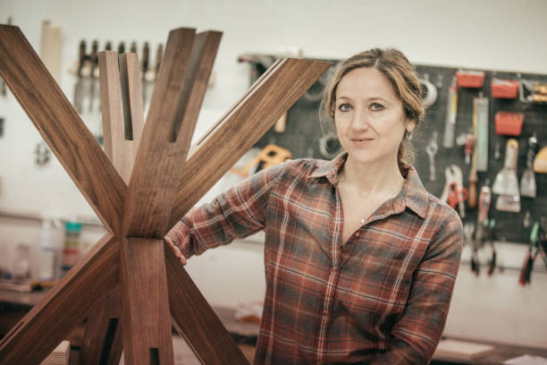 istock Furniture designer at her woodworking shop 645570270