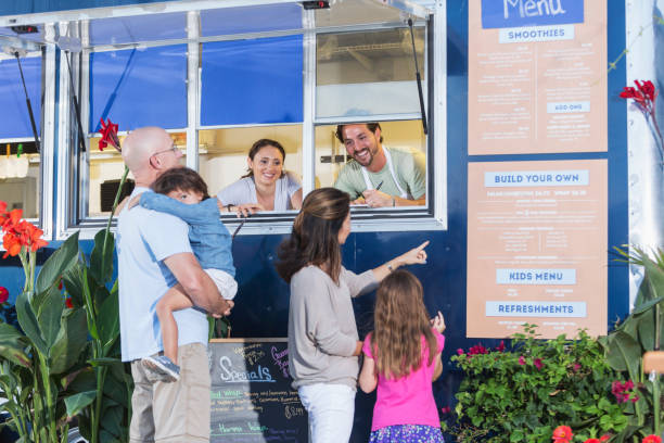 Workers in food truck helping customers