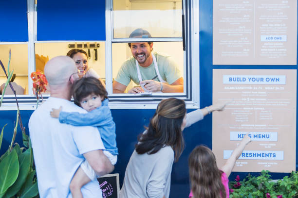 istock Workers in food truck helping customers 645575870