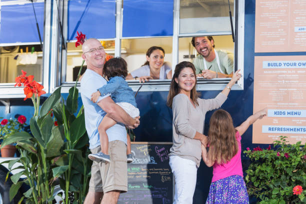 istock Workers in food truck helping customers 645575876