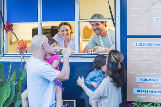 istock Workers in food truck helping customers 645575896