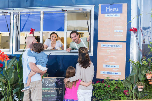 istock Workers in food truck helping customers 645575898