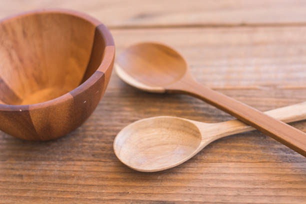 istock Empty wooden bowl and spoon on old wooden background 645594776