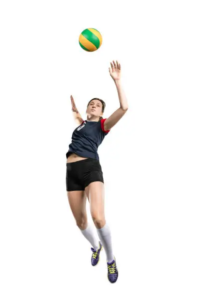 Female volleyball player in the air before hitting the ball isolated on white background