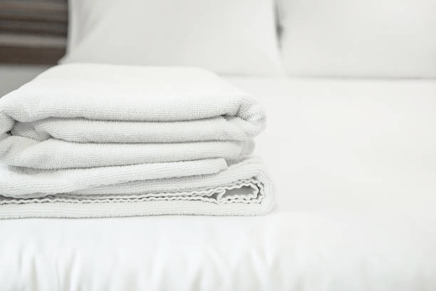 istock white towel on white mattress fabric, soft light in the morning 645598124