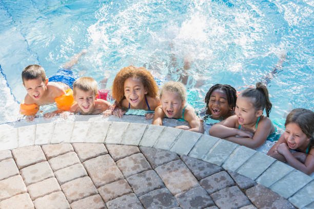 istock Multi-ethnic group of children in swimming pool 645600456