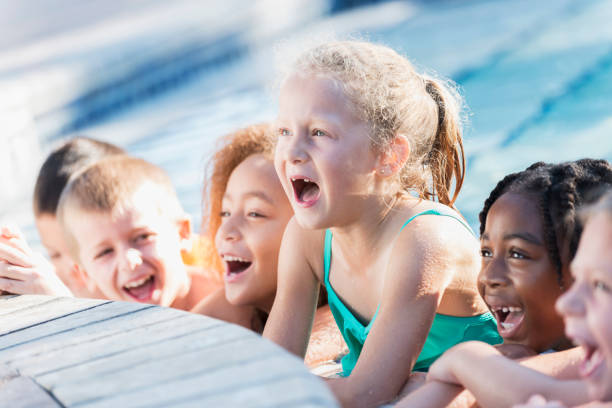 istock Multi-ethnic group of children in swimming pool shouting 645600790