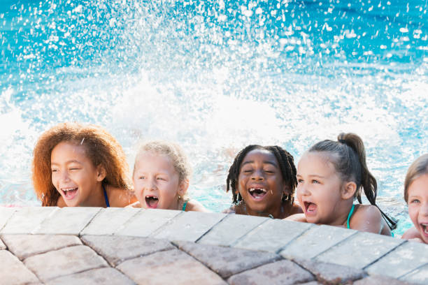 istock Multi-ethnic group of children in swimming pool laughing 645600794