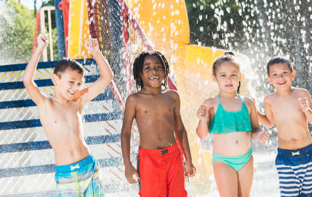 istock Multi-ethnic children at a water park dancing 645600898