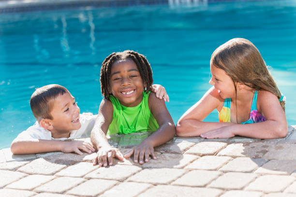 istock Multi-ethnic children hanging on side of swimming pool 645601046