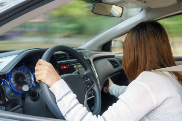 istock woman find something in drawer front of car while driving 645606024