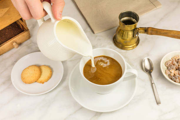 istock Milk poured into cup of coffee 645612286