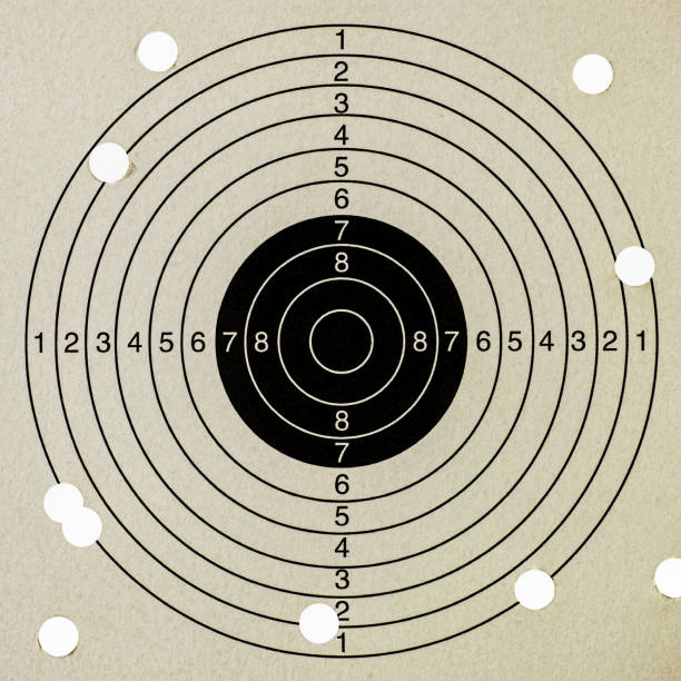 Ten shots at a paper gun target with a very low score. Concept image about missing the target, well out of range, business goals etc.