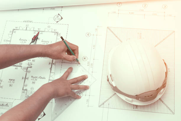 istock Civil engineer tools during worked at home office with white safety helmet ,divider,ruler and blue print. 645618490