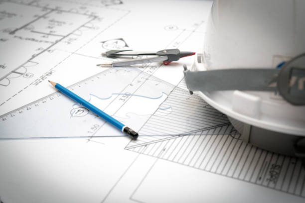 istock Civil engineer tools during worked at home office with white safety helmet ,divider,ruler and blue print. 645618496