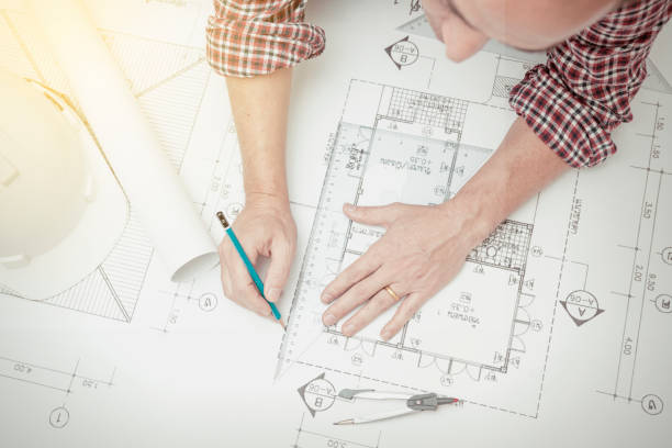 istock Civil engineer during worked at home office with white safety helmet ,divider,ruler and blue print. 645618522
