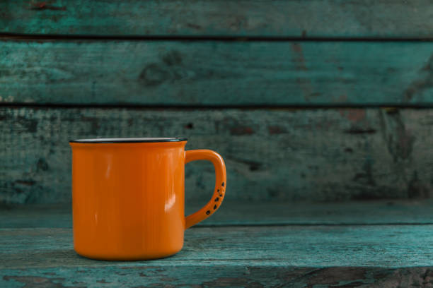 istock yellow cup on the old wooden blue background 645622256