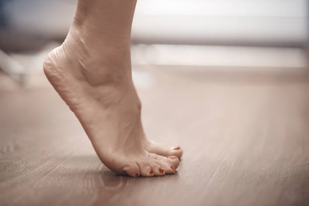 Feet of woman standing on tiptoe Feet of woman standing on tiptoe at home home pedicure stock pictures, royalty-free photos & images