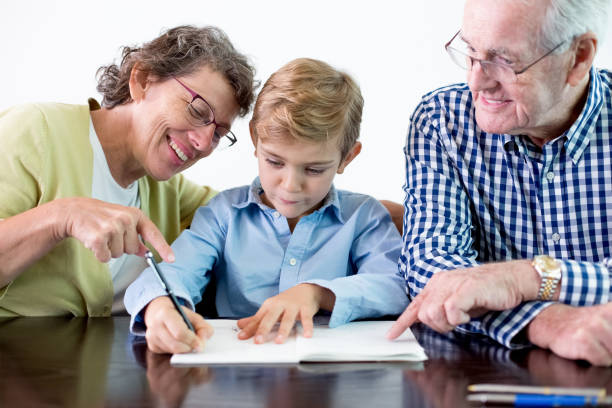 istock Diligent Grandson Doing Homework With Grandparents 645622396