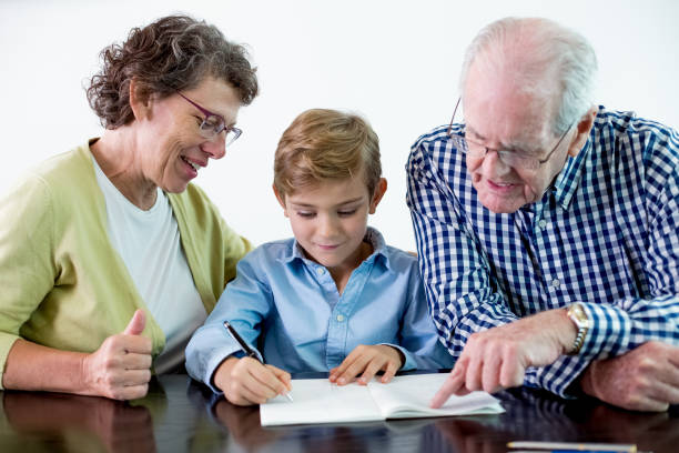 istock Senior Grandparents Helping Grandson With Homework 645622474