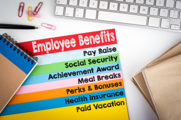 istock Employee Benefits. Office desk with a computer keyboard and color pages 645622812