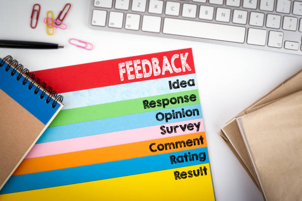 istock Feedback. Office desk with a computer keyboard and color pages 645622824