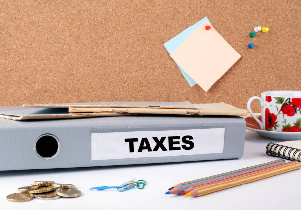 istock Taxes. Folder and money on white office desk 645622828