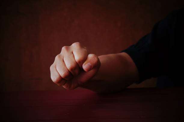 istock Male fist on grey background 645623000