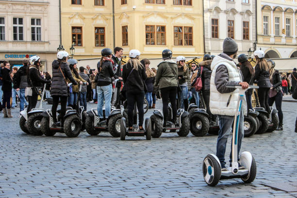 Group of tourists driving Segway in Old Town square in Prague.