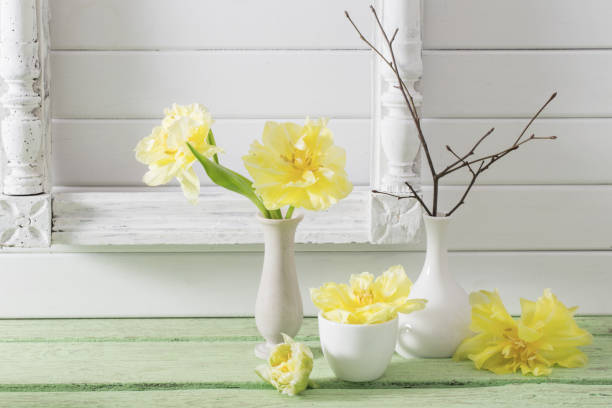 istock TYellow tulips on wooden background 645625584