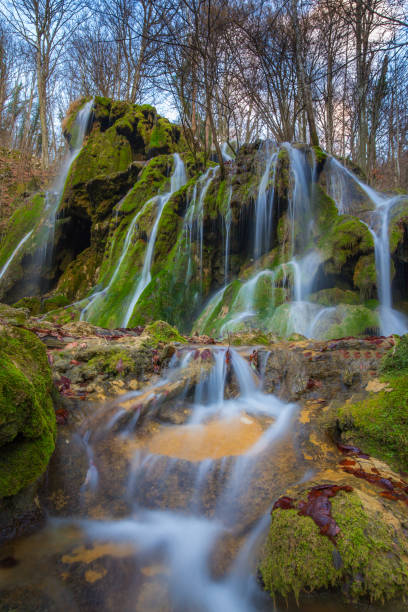 istock Pristine waterfalls deep in the woods, on a bright sunny day in spring 645625932