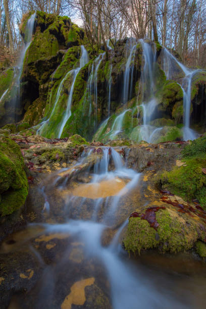 istock Pristine waterfalls deep in the woods, on a bright sunny day in spring 645625948