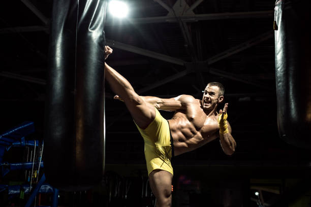 istock Thai boxer punch kick by punching bag 645625986