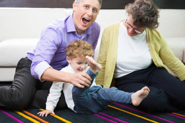 istock Granny and Father Playing With Little Kid on Floor 645626248