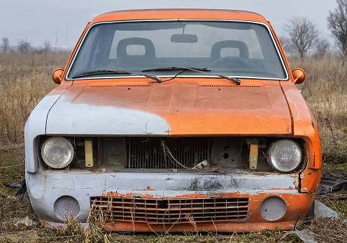 Closeup of the front part of an old abandoned car
