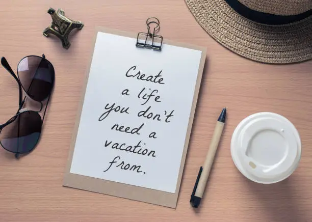 Photo of Inspirational motivating quote on notebook and travel objects with vintage filter