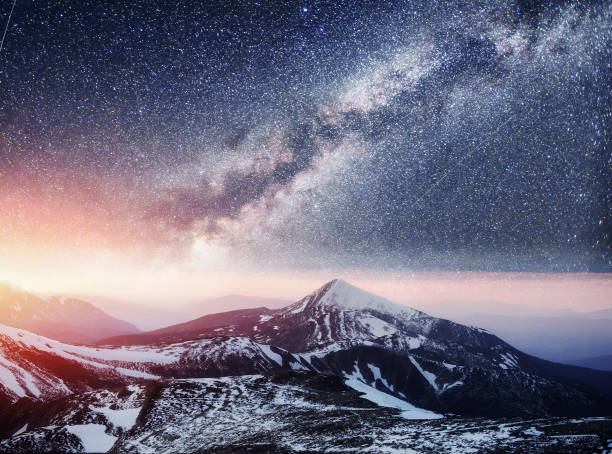 istock Fantastic starry sky. Beautiful winter landscape and snow-capped 645631850
