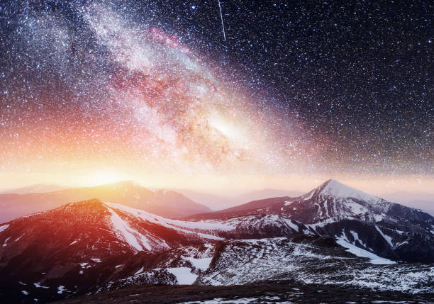 istock Fantastic starry sky. Beautiful winter landscape and snow-capped 645631870