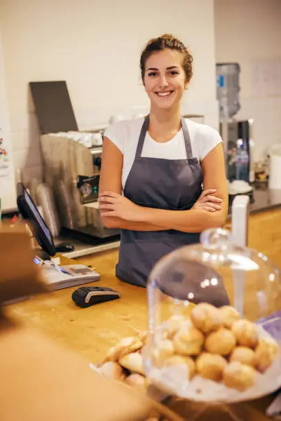 Portrait of barista at a bar counter.